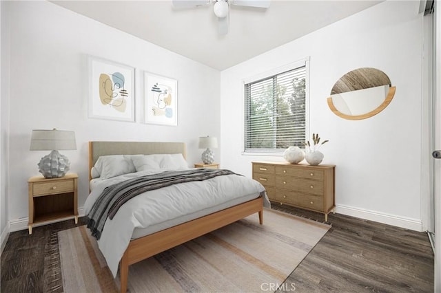bedroom featuring wood finished floors, baseboards, and ceiling fan