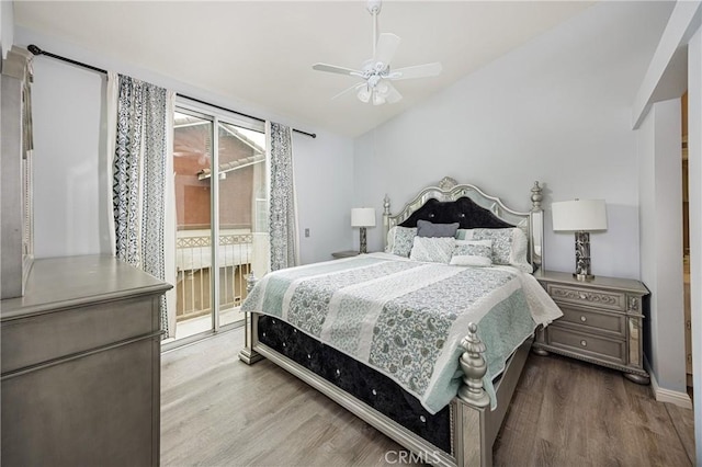 bedroom featuring access to outside, wood finished floors, lofted ceiling, a ceiling fan, and baseboards