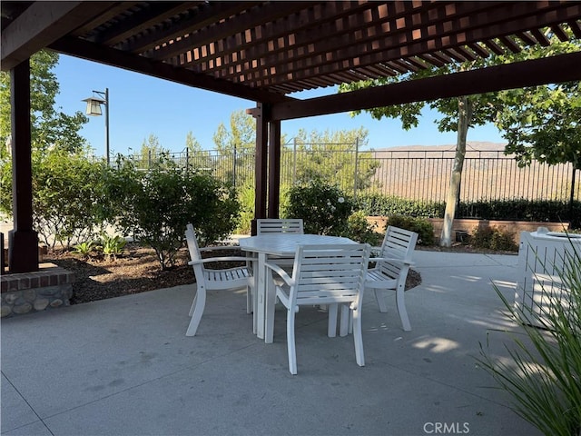 view of patio / terrace featuring outdoor dining area, a pergola, and fence