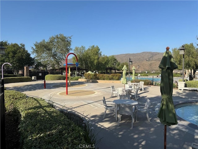 11151 Tesota Loop St, Corona, CA 92883 - surrounding community with a mountain view and a pool