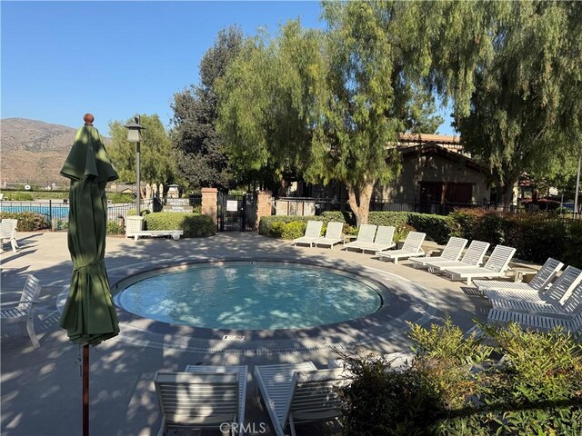11151 Tesota Loop St, Corona, CA 92883 - view of pool featuring a swimming pool, a patio area, and a mountain view