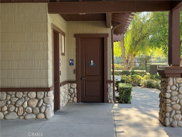 11151 Tesota Loop St, Corona, CA 92883 - doorway to property featuring stone siding