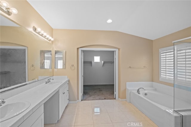 11151 Tesota Loop St, Corona, CA 92883 - full bathroom with a spacious closet, double vanity, a garden tub, tile patterned floors, and baseboards
