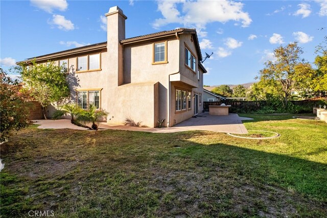 11151 Tesota Loop St, Corona, CA 92883 - back of house featuring a patio, stucco siding, and a chimney