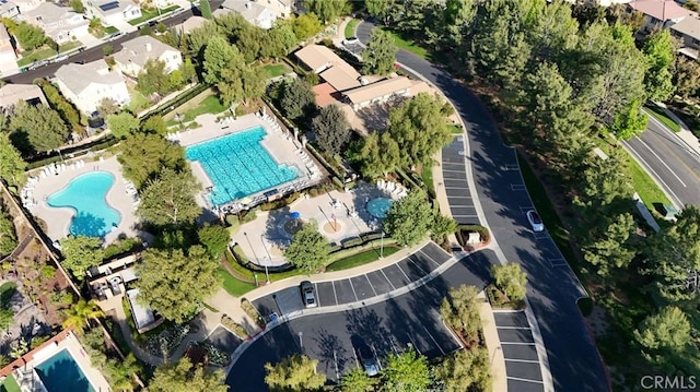 aerial overview of property's location with a pool area and nearby suburban area