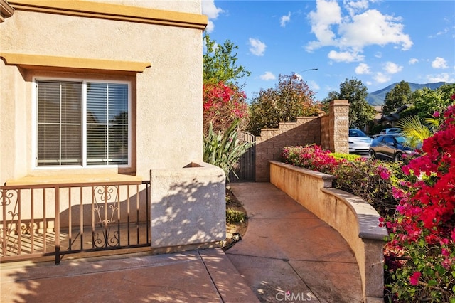 11151 Tesota Loop St, Corona, CA 92883 - view of patio / terrace with a fenced front yard, a gate, and a mountain view