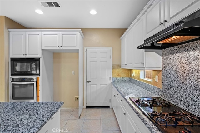 kitchen featuring black appliances, under cabinet range hood, light stone countertops, white cabinets, and recessed lighting