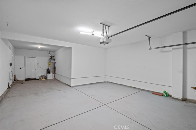 11151 Tesota Loop St, Corona, CA 92883 - garage with a garage door opener, secured water heater, and baseboards