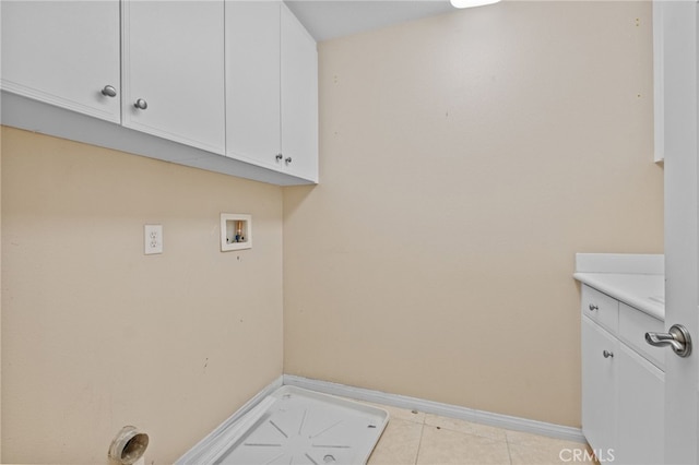 11151 Tesota Loop St, Corona, CA 92883 - laundry area featuring hookup for a washing machine, light tile patterned floors, cabinet space, and baseboards