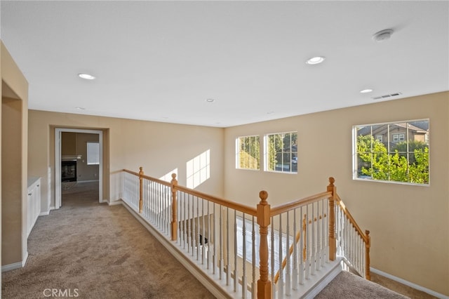 11151 Tesota Loop St, Corona, CA 92883 - hallway with carpet floors, an upstairs landing, baseboards, and recessed lighting