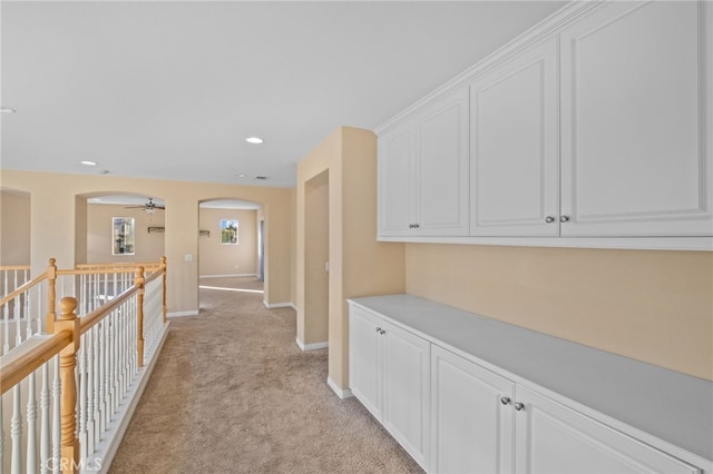 11151 Tesota Loop St, Corona, CA 92883 - hallway featuring arched walkways, light carpet, baseboards, and recessed lighting