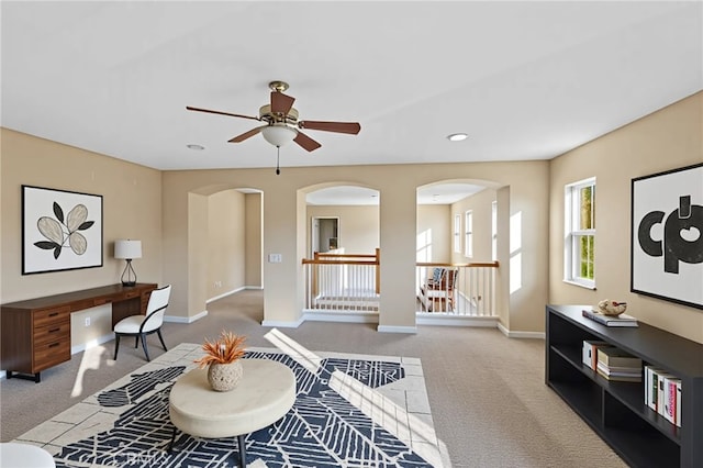 11151 Tesota Loop St, Corona, CA 92883 - carpeted living room featuring arched walkways, a ceiling fan, baseboards, and recessed lighting