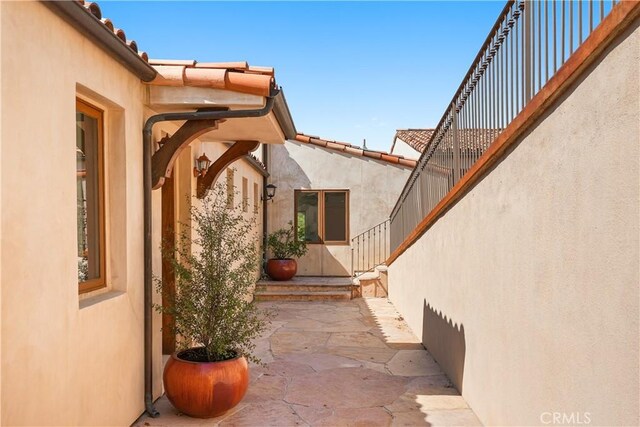 2516 Temple Hills Dr, Laguna Beach, CA 92651 - property entrance with stucco siding, a patio area, and a tile roof