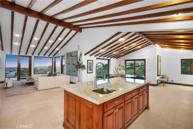 2516 Temple Hills Dr, Laguna Beach, CA 92651 - kitchen with a sink, open floor plan, brown cabinets, light stone counters, and a center island with sink