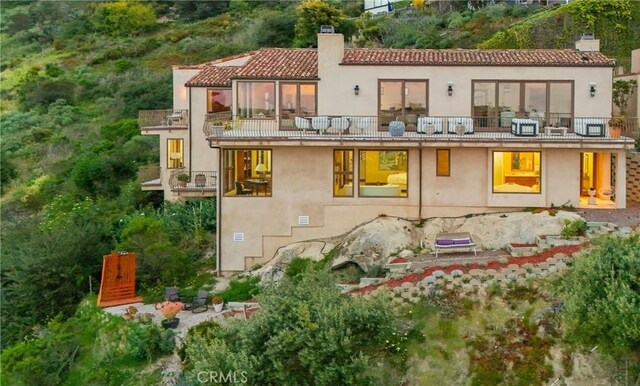 2516 Temple Hills Dr, Laguna Beach, CA 92651 - back of property featuring a balcony, a chimney, stucco siding, and a tiled roof