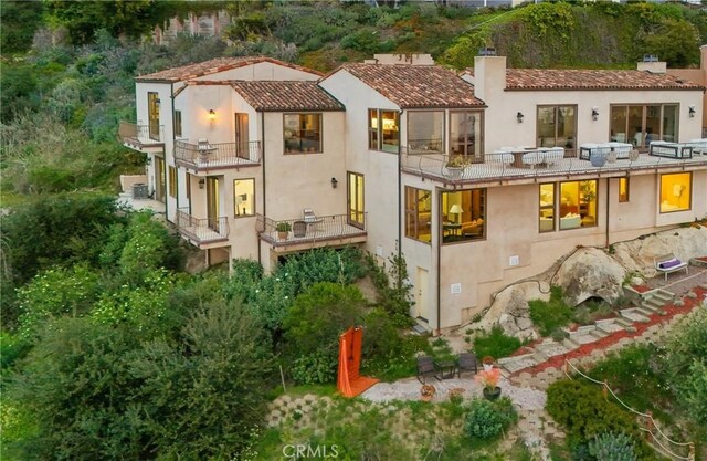 2516 Temple Hills Dr, Laguna Beach, CA 92651 - rear view of property with a chimney, a balcony, and stucco siding