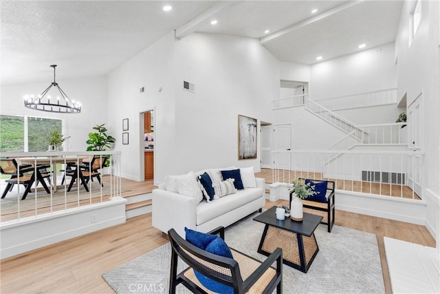 5431 Via Ontiveros, Yorba Linda, CA 92887 - living room featuring high vaulted ceiling, visible vents, a chandelier, light wood-style flooring, and baseboards