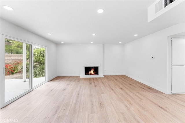 5431 Via Ontiveros, Yorba Linda, CA 92887 - unfurnished living room featuring a lit fireplace, light wood-type flooring, visible vents, and recessed lighting
