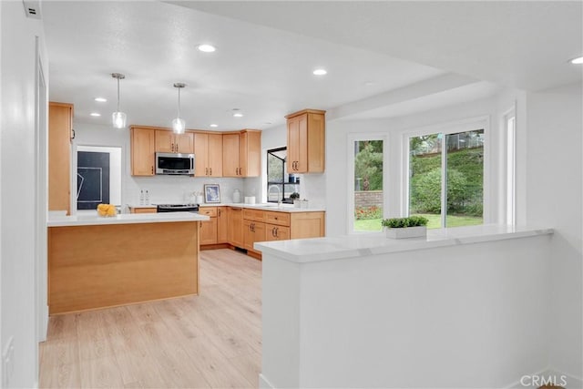 5431 Via Ontiveros, Yorba Linda, CA 92887 - kitchen with a peninsula, stainless steel appliances, recessed lighting, light countertops, and light wood-style floors
