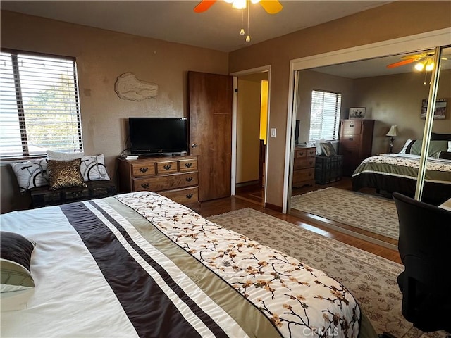 bedroom with a closet, wood finished floors, and a ceiling fan
