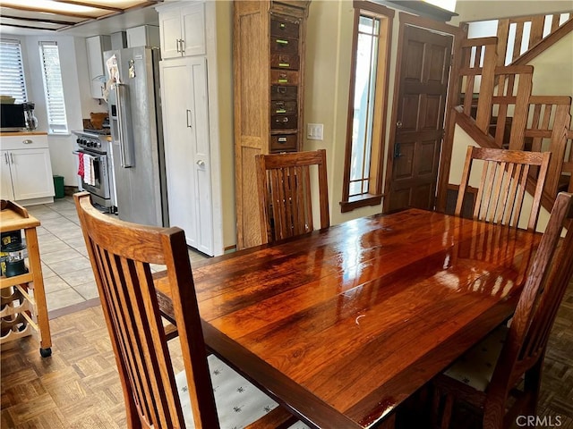 dining space featuring stairs