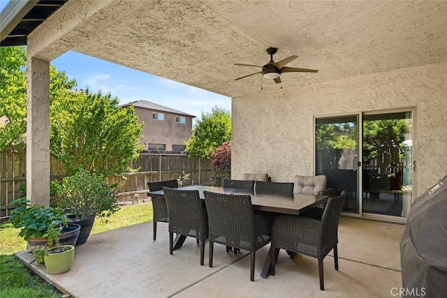 view of patio / terrace with outdoor dining space, a ceiling fan, and a fenced backyard