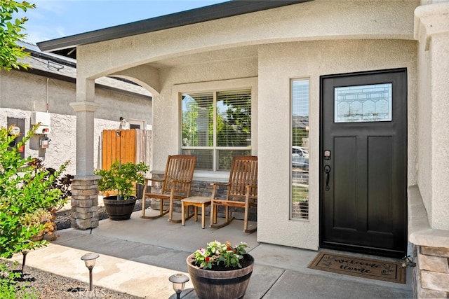 entrance to property featuring stucco siding