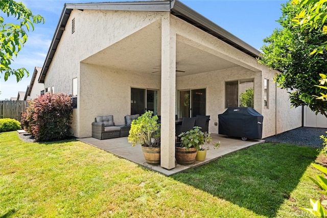back of house with an outdoor living space, stucco siding, and a patio