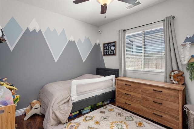 bedroom featuring baseboards, a ceiling fan, visible vents, and wood finished floors