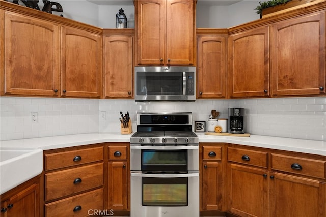 kitchen featuring backsplash, light countertops, and stainless steel appliances