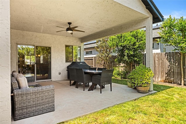 view of patio / terrace with a ceiling fan, outdoor dining space, and fence