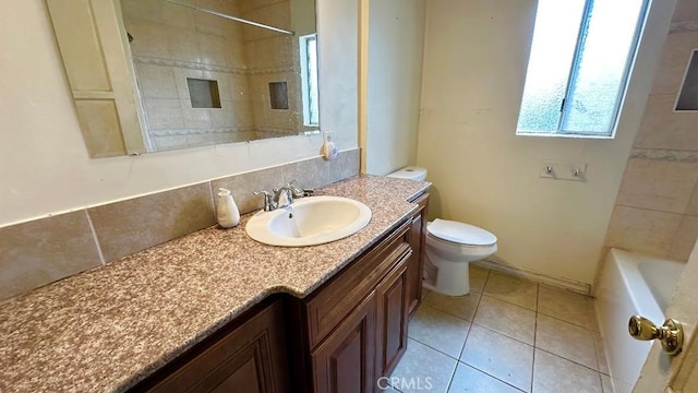 bathroom featuring toilet, tile patterned flooring, and vanity