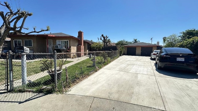 ranch-style home with a chimney, fence, a front yard, an outbuilding, and a detached garage