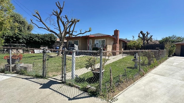 view of front facade with a fenced front yard, a front lawn, a chimney, and a gate