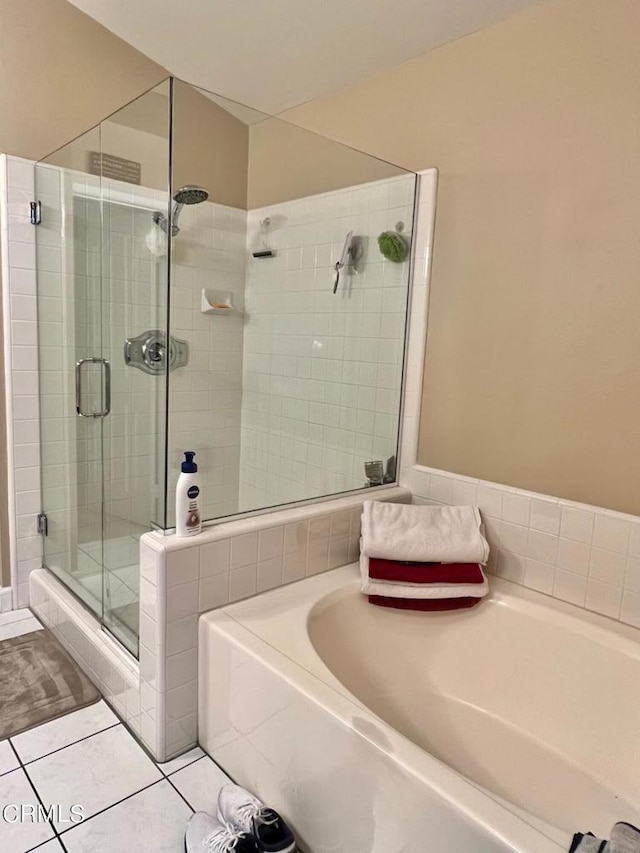 full bathroom featuring a garden tub, tile patterned flooring, and a stall shower