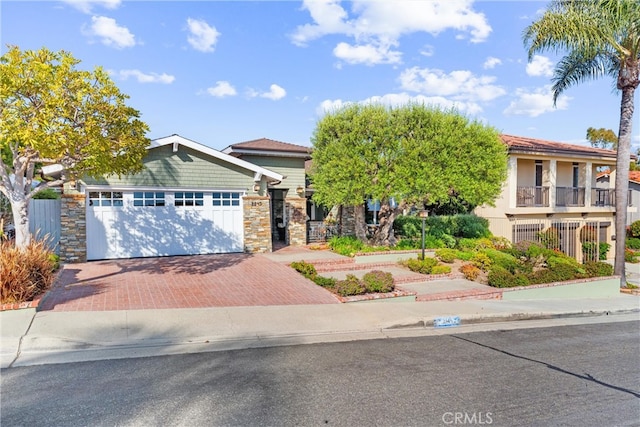 2245 Avenida Salvador, San Clemente, CA 92672 - view of front of house featuring decorative driveway, an attached garage, and stone siding