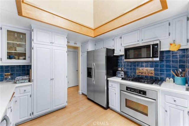 2245 Avenida Salvador, San Clemente, CA 92672 - kitchen with stainless steel appliances, light wood-type flooring, light countertops, and white cabinets