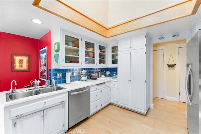 2245 Avenida Salvador, San Clemente, CA 92672 - kitchen featuring appliances with stainless steel finishes, white cabinets, light countertops, light wood-type flooring, and glass insert cabinets