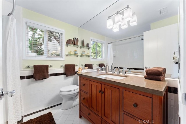 2245 Avenida Salvador, San Clemente, CA 92672 - bathroom with tile patterned floors, vanity, a shower with curtain, tile walls, and a wainscoted wall
