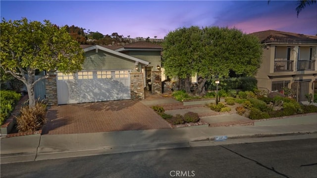 2245 Avenida Salvador, San Clemente, CA 92672 - view of property hidden behind natural elements featuring an attached garage, decorative driveway, and stone siding