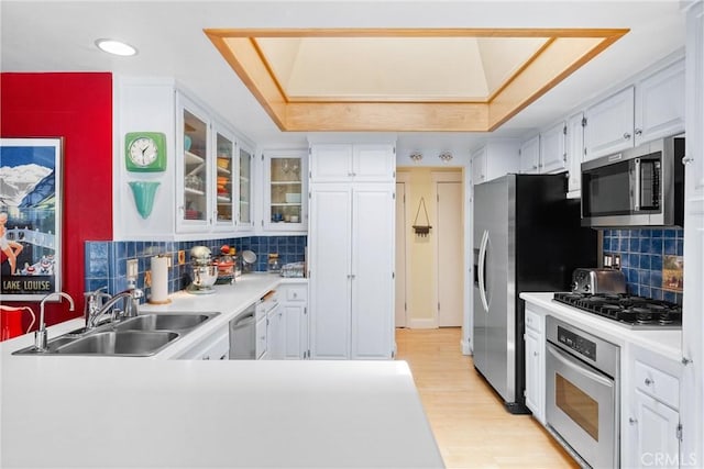 2245 Avenida Salvador, San Clemente, CA 92672 - kitchen with appliances with stainless steel finishes, a sink, white cabinets, light wood-style flooring, and light countertops