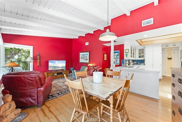 2245 Avenida Salvador, San Clemente, CA 92672 - dining room featuring light wood-type flooring, an accent wall, and wood ceiling with exposed beams