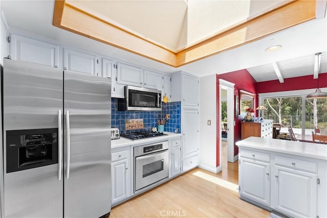 2245 Avenida Salvador, San Clemente, CA 92672 - kitchen featuring stainless steel appliances, vaulted ceiling, light countertops, light wood finished floors, and tasteful backsplash