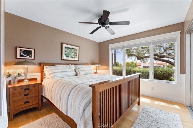 2245 Avenida Salvador, San Clemente, CA 92672 - bedroom with light wood finished floors, wainscoting, and ceiling fan