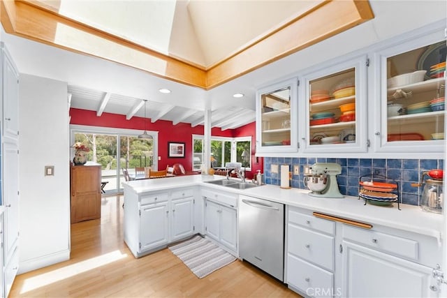 2245 Avenida Salvador, San Clemente, CA 92672 - kitchen with stainless steel dishwasher, light wood-style floors, a peninsula, light countertops, and white cabinets