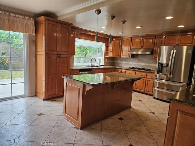 kitchen featuring black stovetop, under cabinet range hood, ornamental molding, a sink, and stainless steel fridge
