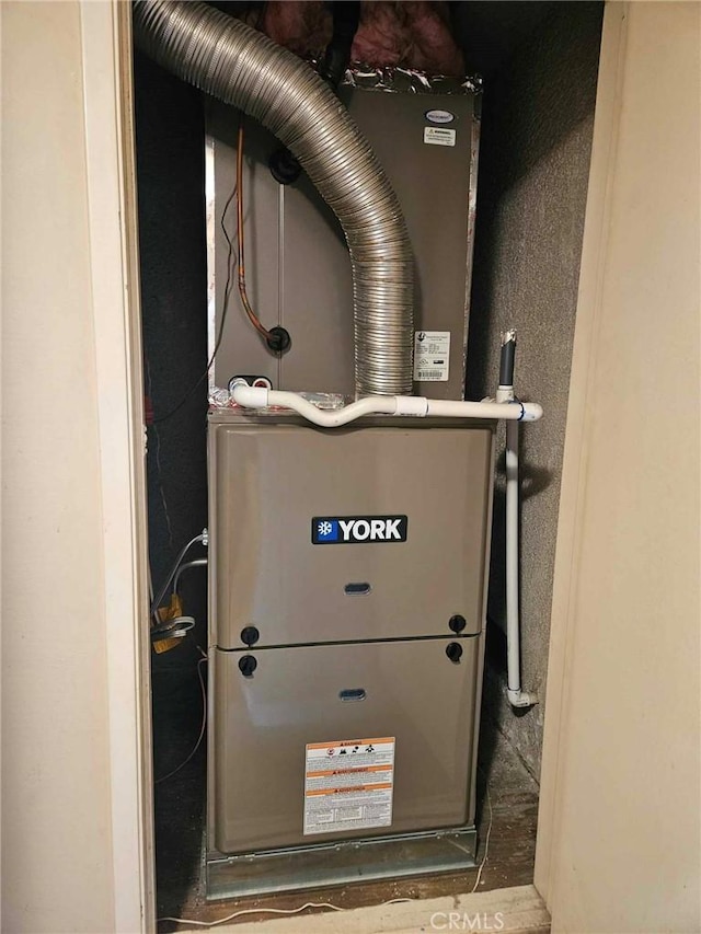 utility room featuring heating unit