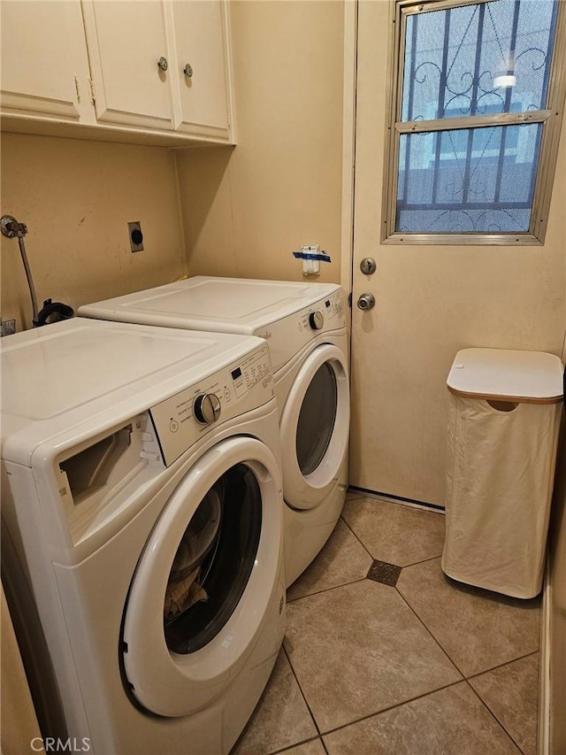 laundry room featuring cabinet space, washer and clothes dryer, and light tile patterned flooring