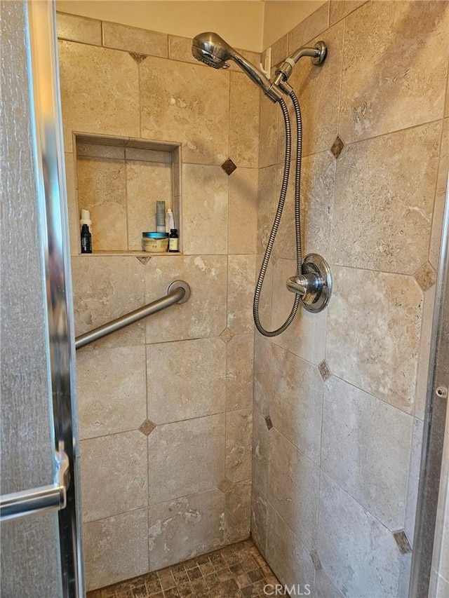 full bath featuring a tile shower