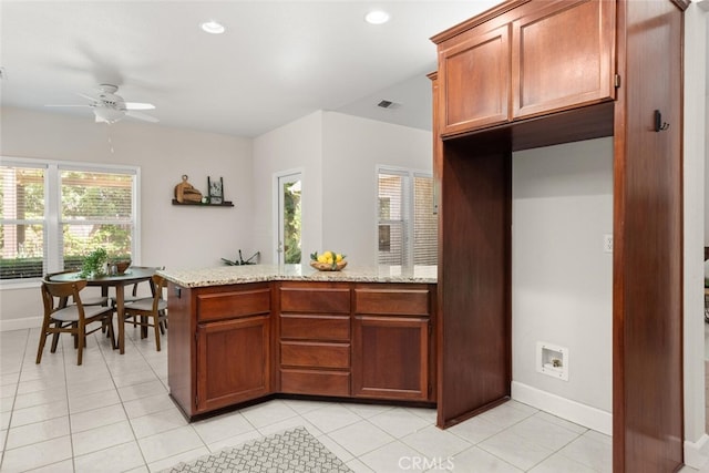 670 Grafton Park Dr, Chico, CA 95926 - kitchen with light tile patterned floors, visible vents, baseboards, light stone countertops, and ceiling fan